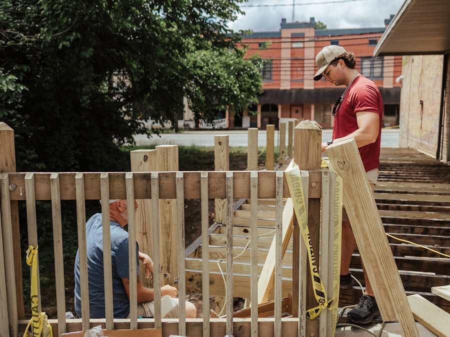 Workers building a timber fence
