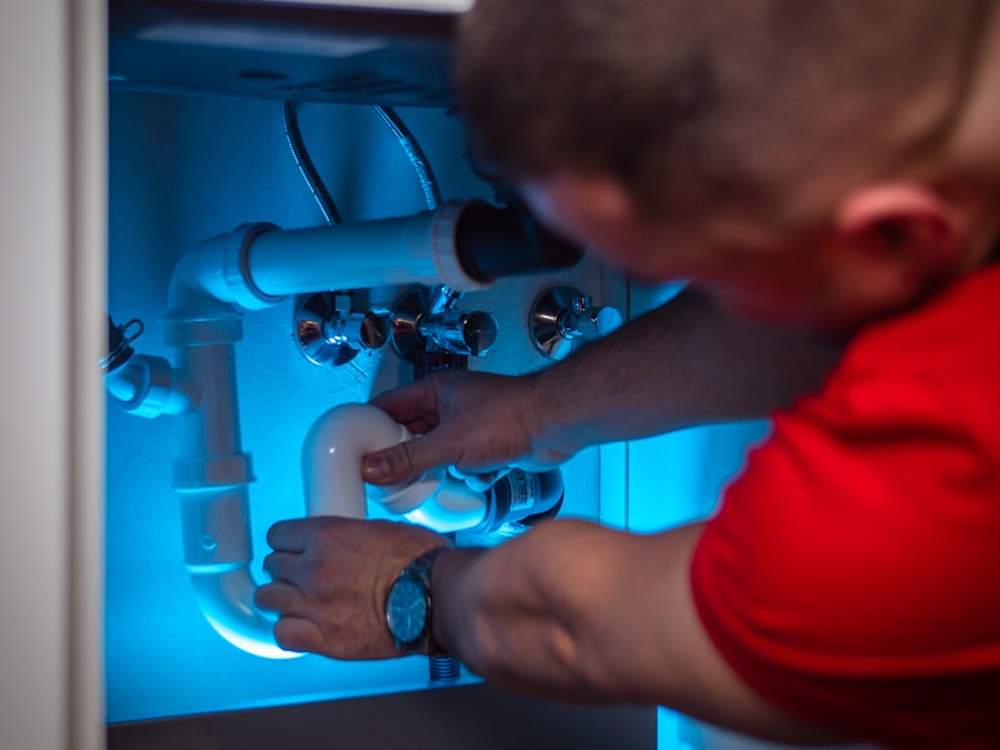 Plumber working on pipes